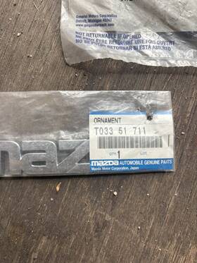 Genuine Mazda T033-51-711 Ornament Rear Manufacturer Name - Part No. T03351711