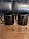 2) Indianapolis Motor Speedway Black Ceramic Mugs Gold Stripes & Lettering. Fixed Price $20.00.